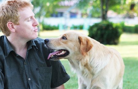 Happy man in the park with his dog