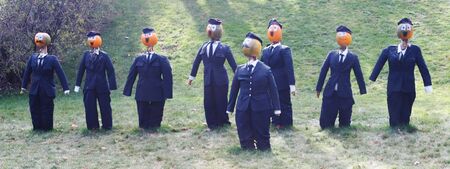 Pumpkin people - businessmen in suits. Taken in Canada during autumn.