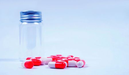 Pills next to an empty jarの写真素材