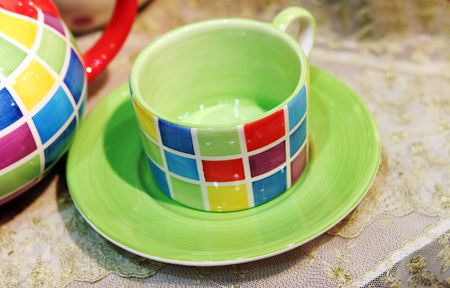 Colorful pottery teacup and saucer - home interiorsの写真素材