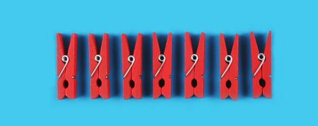 Red pegs isolated on a blue background