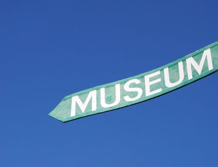 Sign for a museum against a bright blue sky.の写真素材