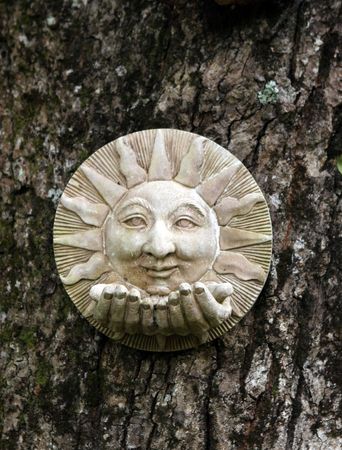 Ceramic garden decoration on a tree trunk.の写真素材