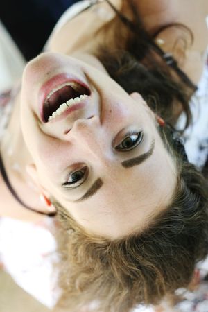 Close-up portrait of a woman laughing and having fun.の写真素材