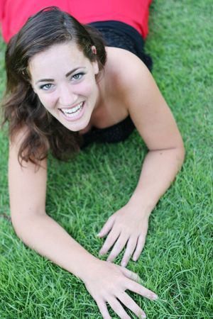 Portrait of a beautiful woman laying on the grass.の写真素材