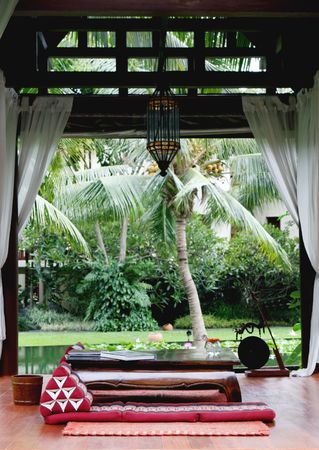 Cushions and table inside a sala in Thailand - travel and tourism.の写真素材