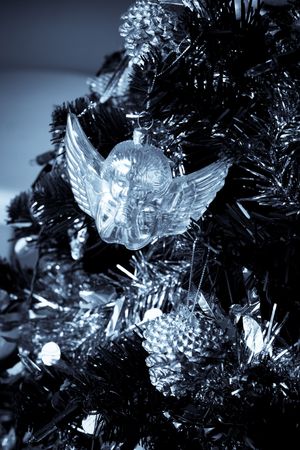 Silver angel Christmas decoration hanging on a tree.の写真素材