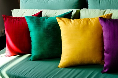 Colorful silk pillows on a sofa - home interiors.の写真素材