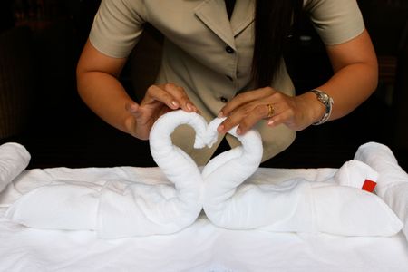 Close-up of a woman folding towels into decorations for an Asian spa.の写真素材