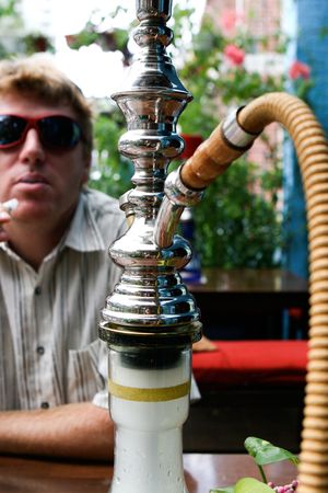 Man smoking a traditional Middle Eastern Hookah.