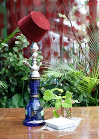Traditional Middle Eastern hookah on a table at a cafe.