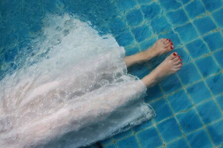 Bride's feet during a trash the dress photo session.の写真素材
