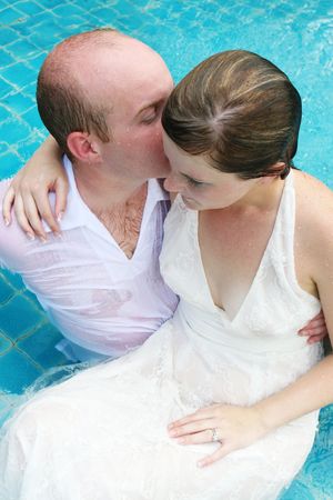 Gorgeous bride and groom in the water during a trash the dress photo shoot.
