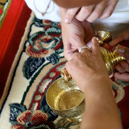 Close-up of hands during a traditional Buddhist wedding in Thailand.の写真素材