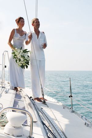 Happy bride and groom on a luxury yacht.の写真素材