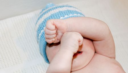 Portrait of a cute young baby in a winter hat.