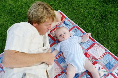 Family portrait of father and son at the park.