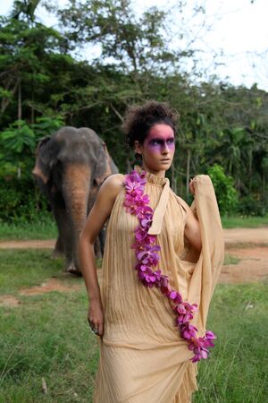 Fashion portrait of a model with an elephant.