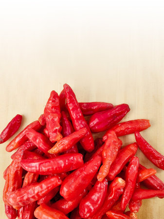 Red hot chili peppers on a wooden board with white space for text