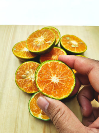Sliced orange fruit on a wooden table.