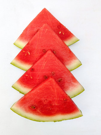 Slices of watermelon on a white background, top view