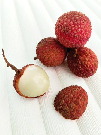 Fresh lychees on white wooden table, closeup. Tropical fruitの写真素材