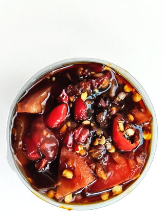 Sweet and sour sauce in a tin can on a white background