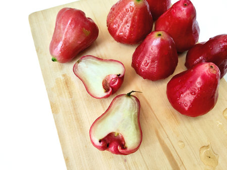 Rose apple on wooden cutting board isolated on white background with clipping path