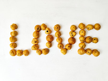 Word LOVE made of cookies on a white background. Top view.の写真素材