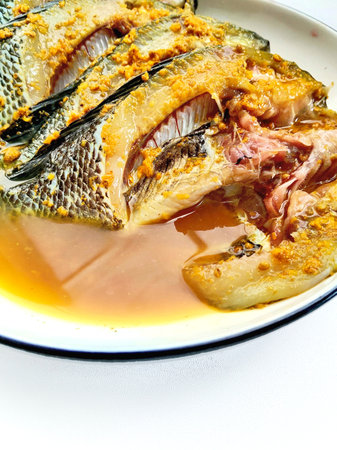 Fried Tilapia Fish in sweet and sour sauce on plate