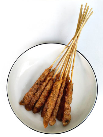 Satay in a white plate on a white background.の写真素材