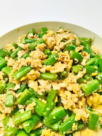 Stir-fried green beans with egg on white backgroundの写真素材