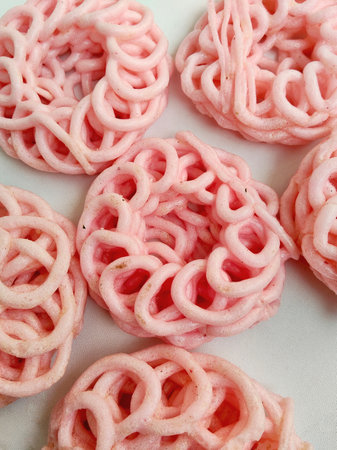 Stacked Pink Indonesian Crackers on a Plain White Background