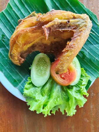 Fried chicken with fresh vegetable on wooden background,Thai foodの写真素材