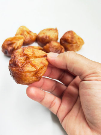Golden-brown Burayot, a sweet and chewy traditional snack from Garut, Indonesia, arranged neatly...