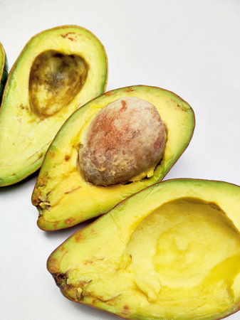 Avocado cut in half on a white background, close-up