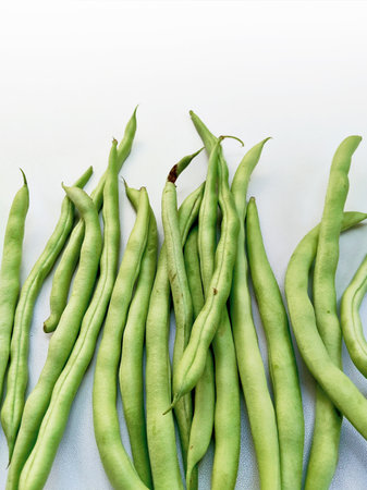 Green beans on a white background with space for text. Top view.