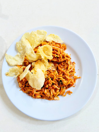 Rice bolognese with chips on white plateの写真素材