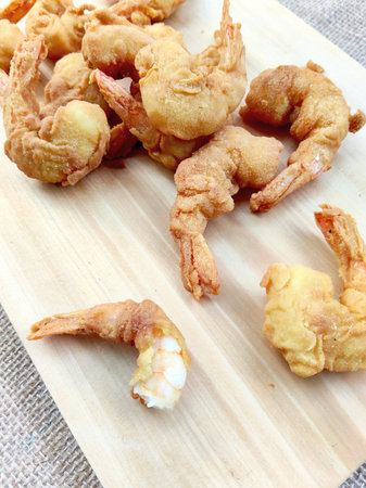 Fried shrimp on wooden cutting board. Shrimp tempura.