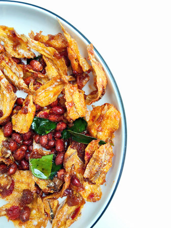 Fried fish with chili in white dish on white backgroundの写真素材