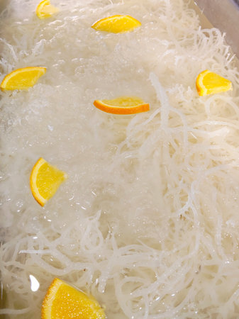 Refreshing Dessert of White Seaweed Jelly and Orange Slices Served on a Bed of Crushed Iceの写真素材