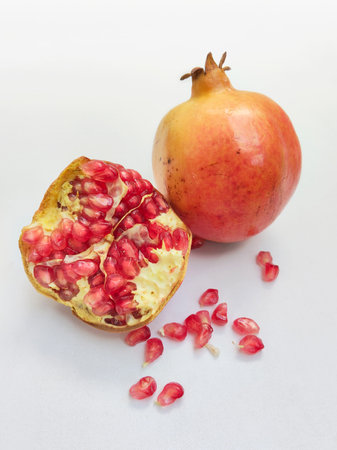 Pomegranate fruit with seeds isolated on white background close upの写真素材