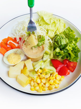 Salad with lettuce, corn, tomato, egg and mayonnaiseの写真素材