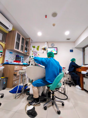 Modern Clean Dental Clinic Interior with Operating Equipment and Staff in Blue Uniformsの写真素材