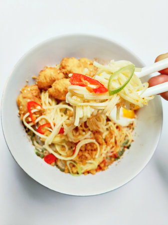 Fried rice noodle with chicken and vegetables on white background.