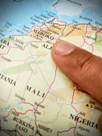 Close up of a person pointing at Morocco on map