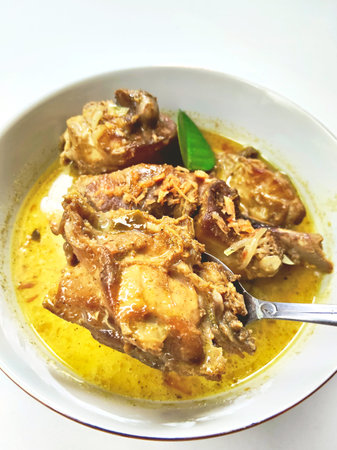 Delicious Indonesian Yellow Curry Chicken In White Bowlの写真素材