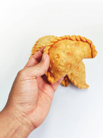 Person Holding Fresh Fried Indonesian Pastel Snackの写真素材