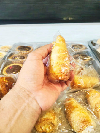Person holding wrapped local bakery bread