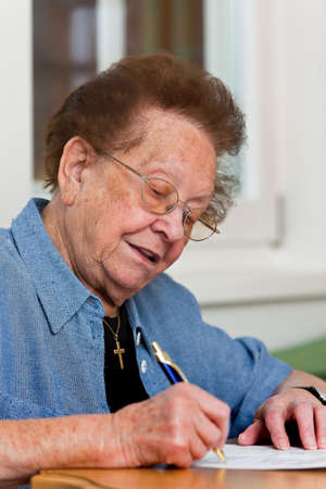 Old woman writes a letterの写真素材